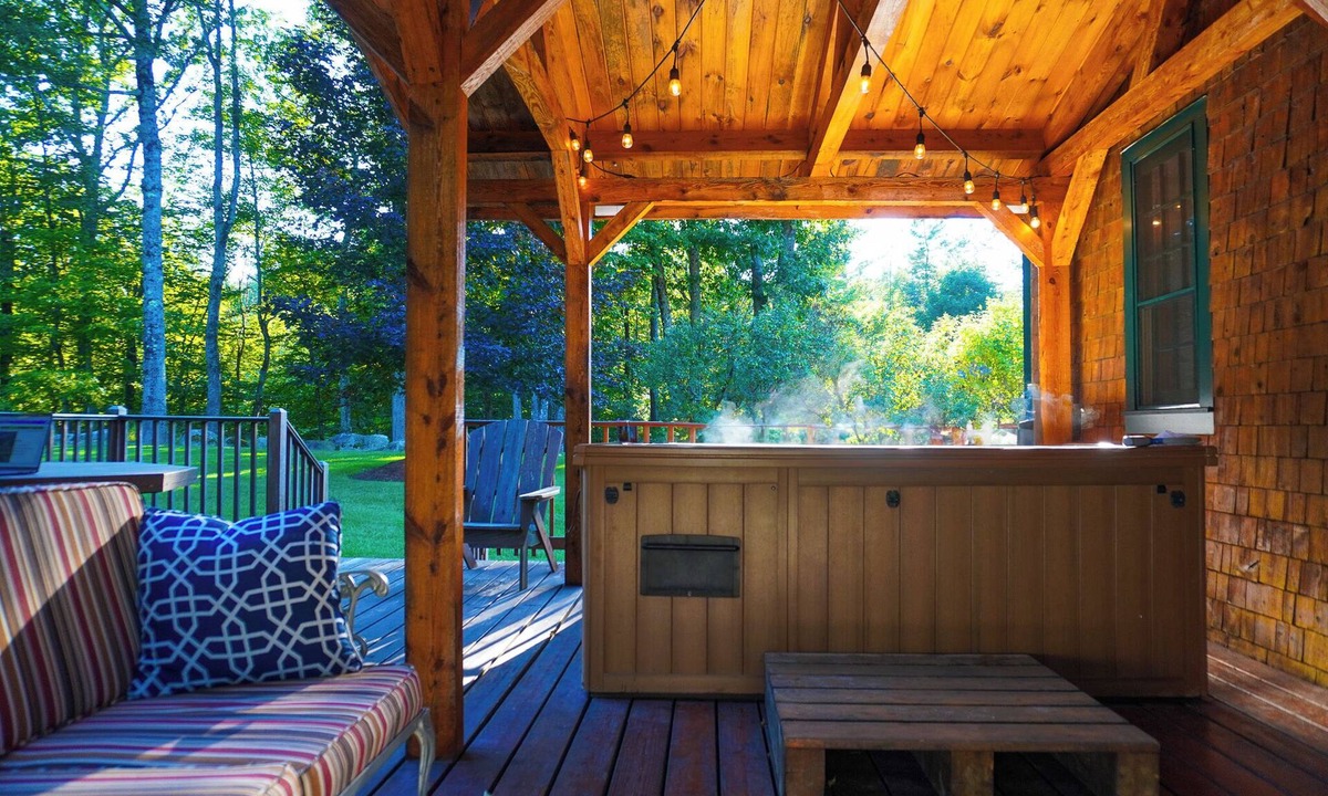 Holderness House | Central Escape is a spacious Lakes Region retreat just 5 minutes from downtown Meredith, less than a mile to Squam Lake and 20 minutes to concerts at the Bank of New Hampshire Pavilion. Enjoy the private year-round hot tub, fire pit, yard games!
