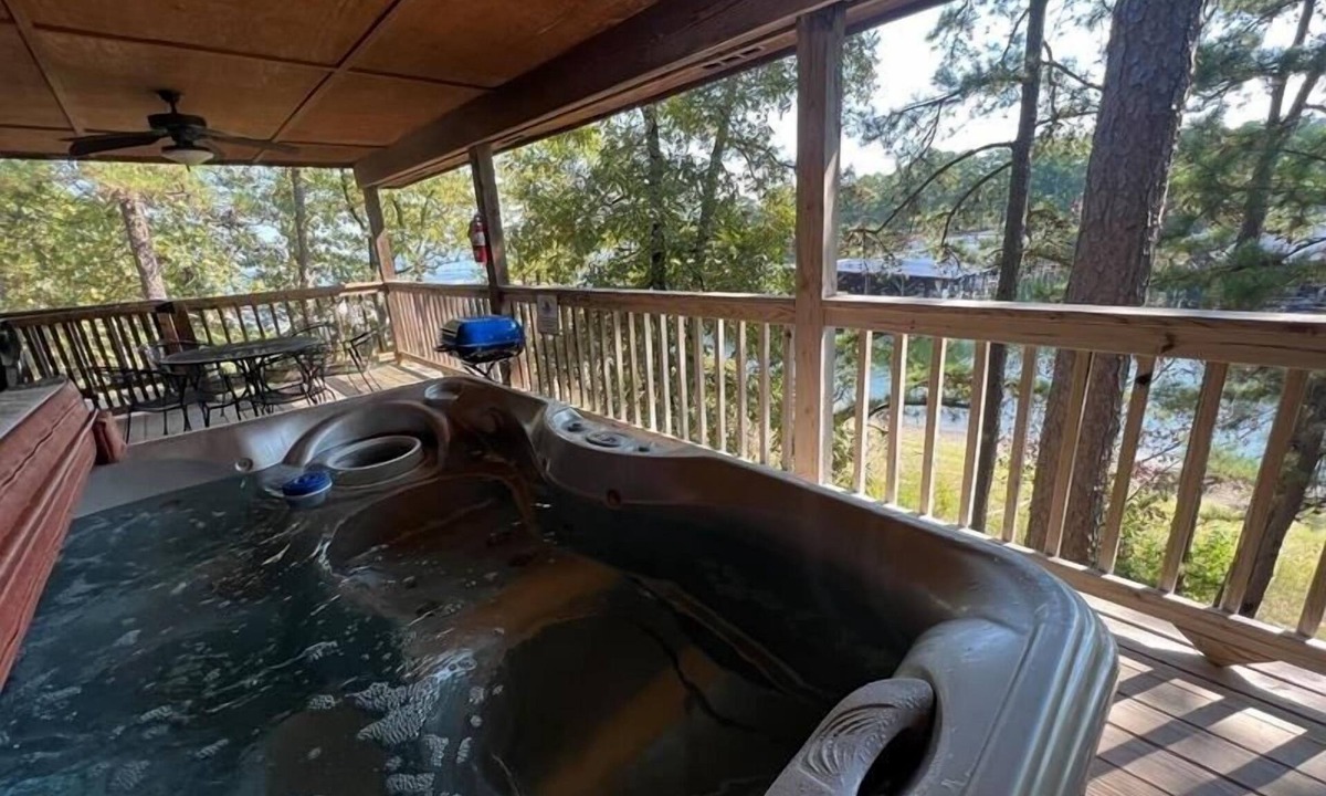 Mount Ida Cottage | Lake view two bedroom, two bath log-sided cottage with private hot tub overlooking Lake Ouachita. by RedAwning
