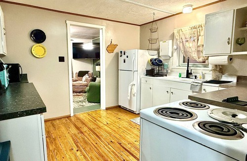 Valley Bend Cottage | Charming 2 BR, nestled on Buckhannon River, with deck, dock, fire-pit, & kayaks