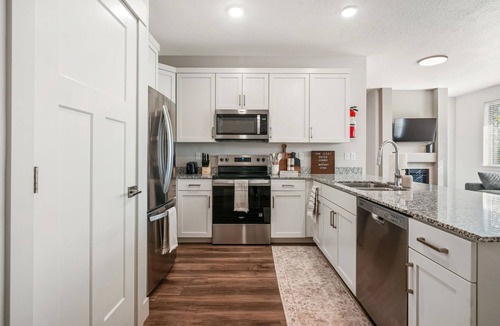 Midway Condo | Cozy Swiss Condo - King Bed, Sleeps 6, Free Blanket