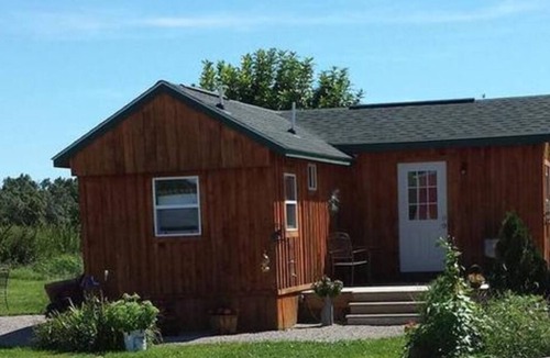 New Plymouth Cabin | Located behind a tree filled garden near our horse barn and Farm Sanctuary.