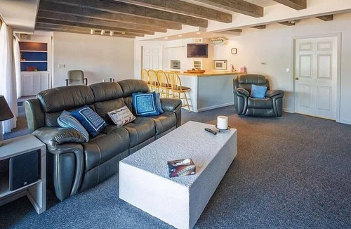 Milton House | Luxury Lakehouse with Large Private Beach, Hottub, Tiki Bar, 100’ Covered Deck, and Dock