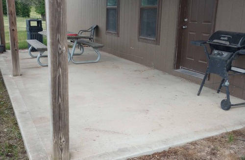 Gallatin Cabin | Nestled in nature, the cabin resides near a tranquil pond, perfect for fishing