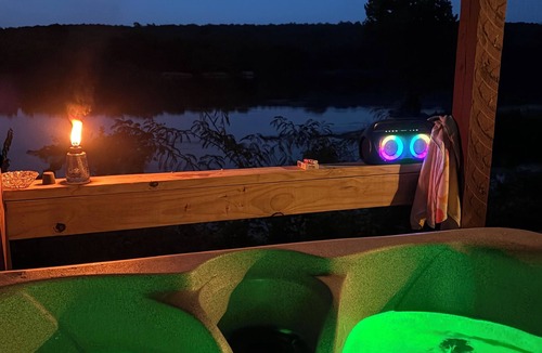 Pleasant Grove Cabin | Riverfront cabin with hot tub and amenities galore!