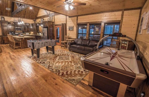 Hochatown Cabin | Soaring cathedral ceilings, gas rock fireplace, large hot tub, smart tv, games.