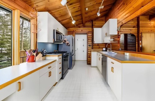 Sand Lake House | Spacious Lakeside Home with Firepit, Wraparound Deck, Kayaks & Gym