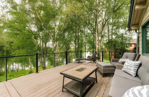 Sand Lake House | Spacious Lakeside Home with Firepit, Wraparound Deck, Kayaks & Gym