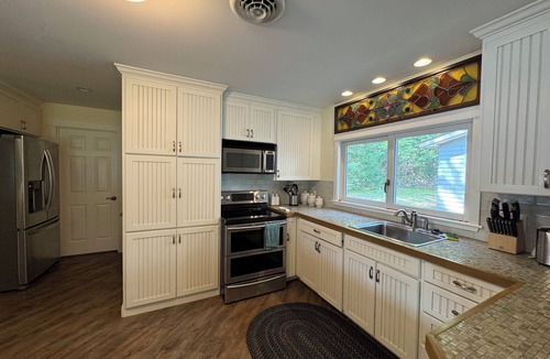 Sanbornville House | Stunning lakefront home with a boathouse, private dock, firepit and lake views