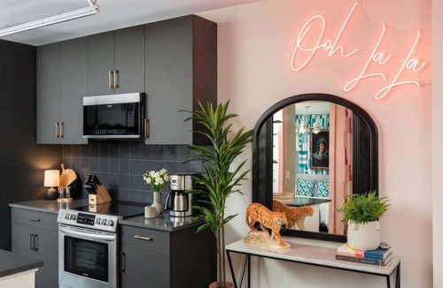 Rolling Mill Hill Apartment | Summer rooftop deck, skyline views, garage-door kitchen near Broadway