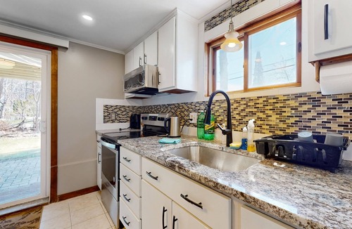Sandown House | Two-story dog-friendly home with a lake view, deck, gas grill