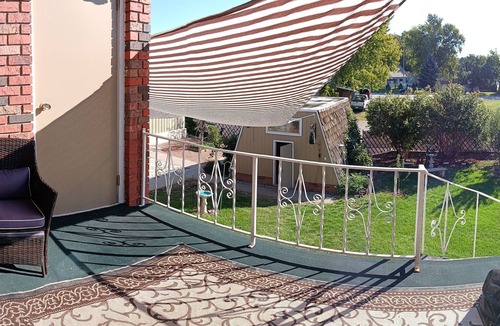 Holdrege Apartment | Uniquely comfy 2nd story, private entrance, outdoor balcony, fence, off street