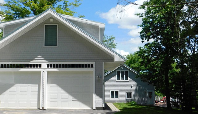 Beautiful home on Sebago Lake Basin with expansive yard and sandy beach!