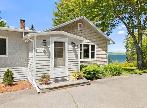 Charming home with stunning bay views, sunroom, gazebo, deck, & grill
