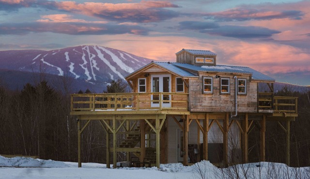 Insanely romantic treehouse perched next to a stream and rolling hills.