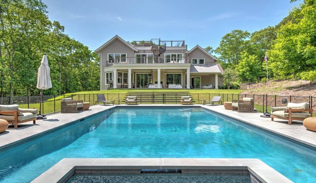 Modern-style home with heated private pool, open-floor plan, ample natural.