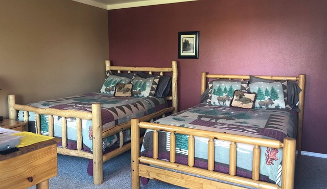 Moose Is Inn Room 2- Two double beds with a balcony view
