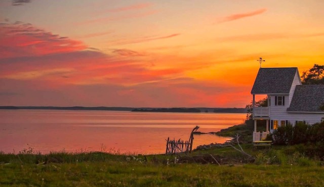 Sea-Breeze Cottage perched on the edge of the bay.