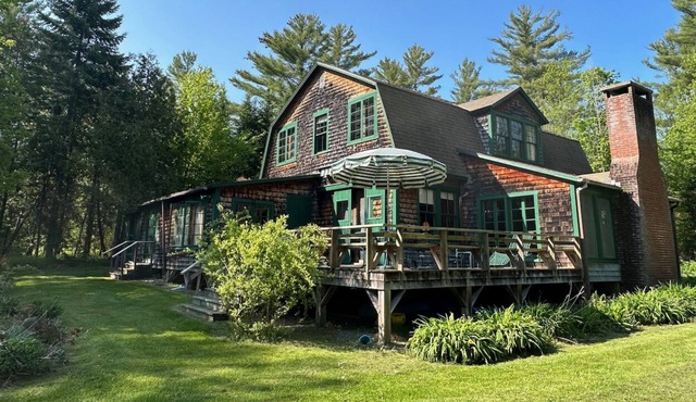 Spacious, rustic getaway on Caspian Lake with two docks & lawn.