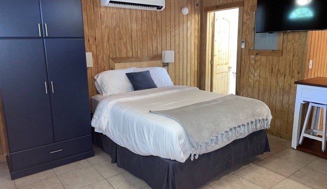 Studio cabin #3 with lake view and boat dock access, outdoor seating.