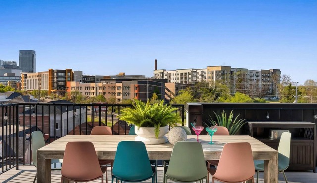 Summer rooftop deck, skyline views, glass garage door near Broadway